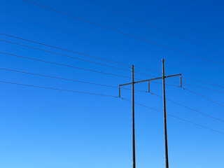 Power lines against a blue sky. Concept of hydro electric, energy, the grid.