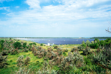 Fototapeta na wymiar Panoramic view of photovoltaic power station, solar park, solar farm, solar power plant. Banner with modern solar farm