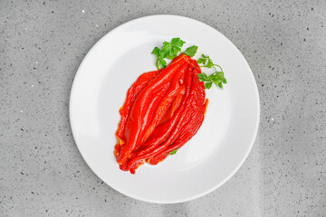 Delicious food from grilled red peppers. Food in the form of a female genital organ