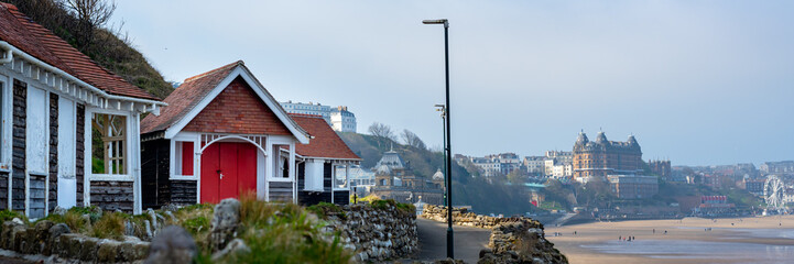 Colorful old beach huts or summer houses on South Bay Beach at Scarborough, Yorkshire, UK. Houses are old, paint cracks, banner size