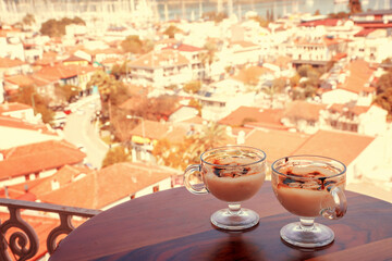 Sweetness for breakfast on the background of the seaside city. Traditional Turkish pudding. Delicious treat from Turkey. A postcard from Turkey