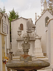 Fototapeta premium Gravetomb with bust of a sad man in Alto de Sao Joao cemetery, Lisbon, Portugal 