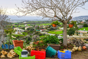 Fototapeta premium Cypriot nature view in spring with colorful plastic boxes in the foreground