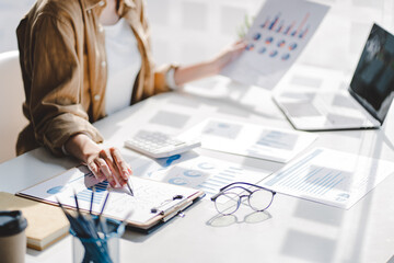 Portrait of a business woman working on a tablet computer in a modern office. Make an account analysis report. real estate investment information financial and tax system concepts