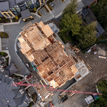 Halfway ready wood framing of a new six story apartment building at construction site in the city