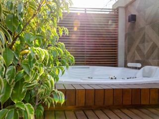 garden wooden deck with a jacuzzi at sunlight - obrazy, fototapety, plakaty