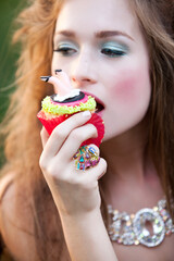 High Fashion Beauty Model with Makeup wearing Jewelry Holding Whimsical Alice in Wonderland Inspired Cake