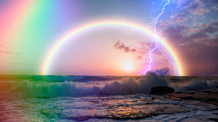 Beautiful landscape with strong sea wave with double sided rainbow and lightning at sunset
