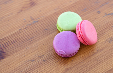 Three macarons arranged in a composition..Multicolored cookies.