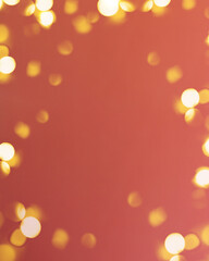 Christmas bright gold colors bokeh different sizes around the frame on vibrant red blurred background. Holiday template and shiny greeting concept with copy space.