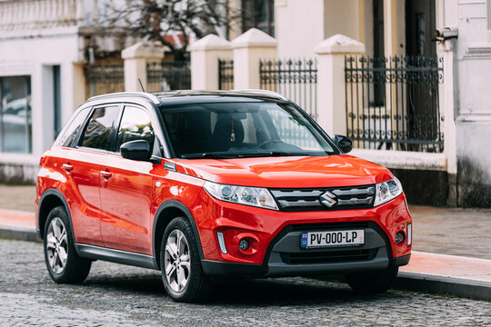 Batumi, Adjara, Georgia - March 20, 2022: Red Suzuki Vitara car parked on street. Compact crossover SUV