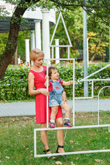 Obraz premium beautiful mother with her daughter in the park in summer