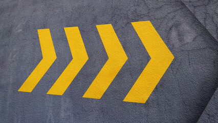 a wall with yellow arrows pointing to the right