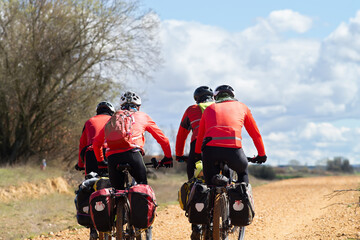 Obraz premium Way of St James , Camino de Santiago , pilgrims cycling to Compostela near Astorga , Leon, Spain