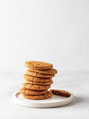 Stack of oatmeal cookies on white plate