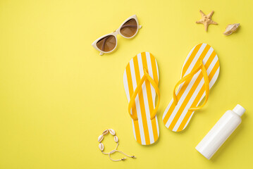 Summer rest concept. Top view photo of yellow striped flip-flops sunglasses sunscreen bottle shell...