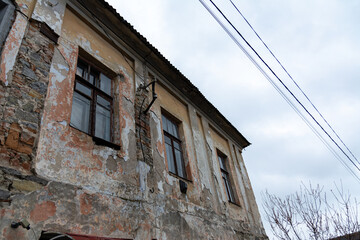 Windows of an old vintage stone house on a cloudy day