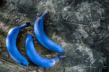 fresh beautiful bananas on a gray background, delicious fruits