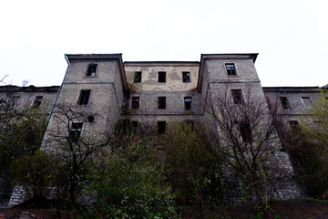 An old abandoned stone building is collapsing in the open air