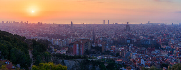 Panoramic view on the sunrise above Barcelona city in Spain. Sagrada Familia among all other architecture and buildings. Travel photography. Best destination for tourists in Europe.