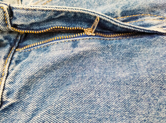 Zipper on jeans. Jeans texture. Close-up denim background. Unzipped jeans.
