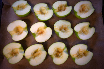 Halves of green apples on a baking sheet.Cooking apples in the oven. Apple in half.