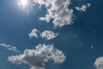Bright beautiful white clouds against the midday blue sky.