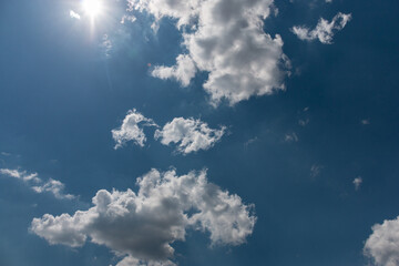 Fototapeta na wymiar Bright beautiful white clouds against the midday blue sky.