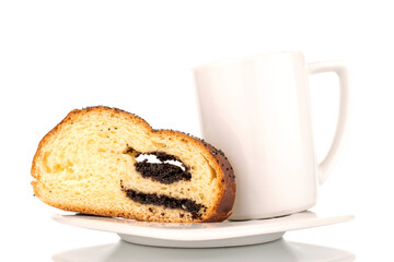 One slice of homemade poppy seed roll with a ceramic cup on a ceramic saucer, close-up, isolated on a white background.