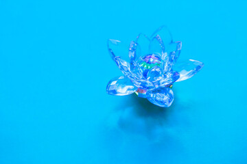 Crystal lotus on blue table. Vishuddha chakra symbol