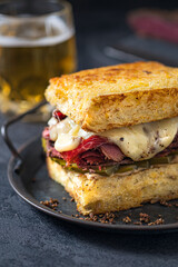 Sandwich with beef pastrami on wooden board