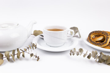 white porcelain cup with tea for tomorrow on the table with a saucer