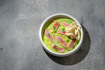 Restaurant dish: fresh tuna tartar on avocado puree op view