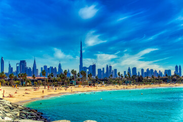 Fototapeta premium View over sandy beach and Dubai downtown panorama in Dubai, UAE.