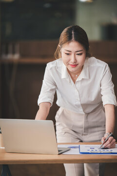 Portrait of a business woman working on a tablet computer in a modern office. Make an account analysis report. real estate investment information financial and tax system concepts