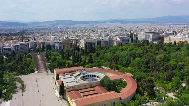 Aerial drone video of iconic public Zappio hall used for events and whole Athens cityscape at the background, Attica, Greece
