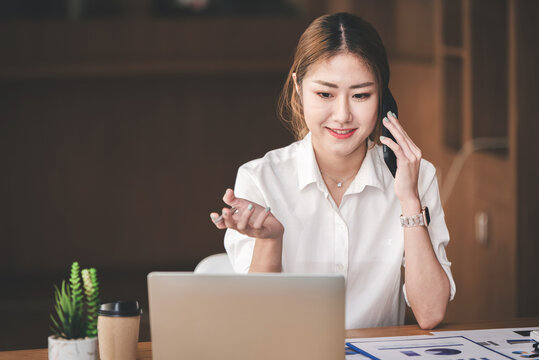 Portrait of an Asian woman working on a tablet computer in a modern office. Make an account analysis report. real estate investment information financial and tax system concepts