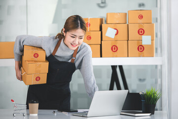 Portrait of a Small Business Startup, SME Owner, Female Entrepreneur work on parcel boxes Receipts and check orders online to prepare boxes. Selling to customers. Online SME business idea.