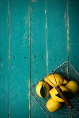 lemons in basket on blue wooden board