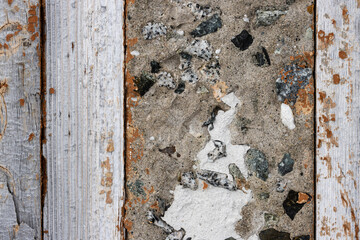 Fragment of an old wall made of concrete and wood. Rustic texture for background and design.