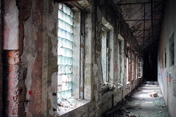 Fototapeta na wymiar Old destroyed hallway with shabby walls and windows, Red Triangle Factory