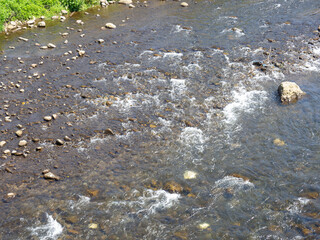 Rapid flow of the river. Big river, view from above. View from the bridge to the water.