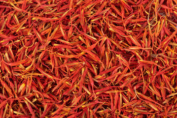 Fototapeta premium A mound of red saffron. Dry saffron spice isolated on white background. Dry saffron flower.