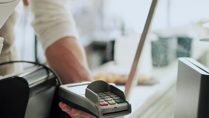 Video of customer using her credit card to make payment with electronic reader in the restaurant. - Powered by Adobe