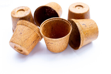 Coco coir pots on white background.