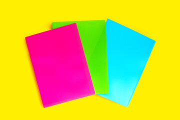 Office folders on yellow background. Top view