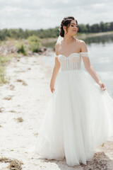 Fototapeta na wymiar beautiful young woman with flowers.summer girl. bride near a lake