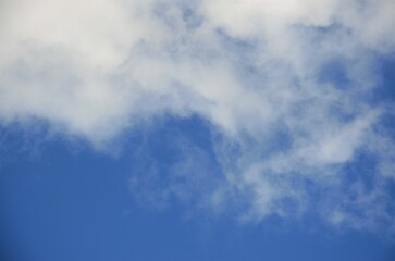 Obraz premium blue sky background with white clouds, minimalism