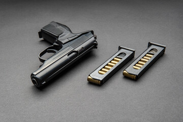 Pistol and cartridges for it on a dark background. A short-barreled weapon for self-defense.