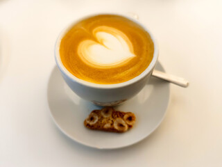 drinking a hot cup of coffee with milk  latte and foam  mug at a restaurant